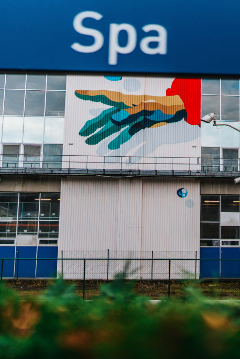 Spa Monopole building with colorful mural artwork on the facade